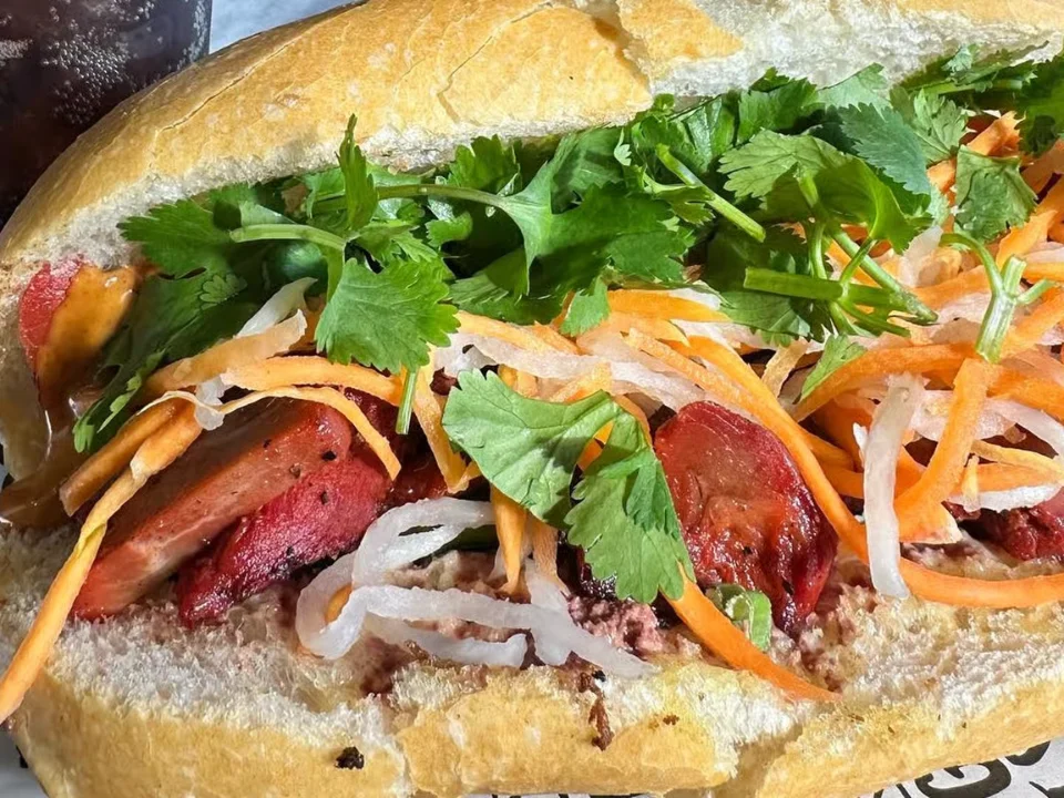 BBQ Roast Pork Po Boy - A New Orleans classic with a Vietnamese twist, featuring savory BBQ roast pork.